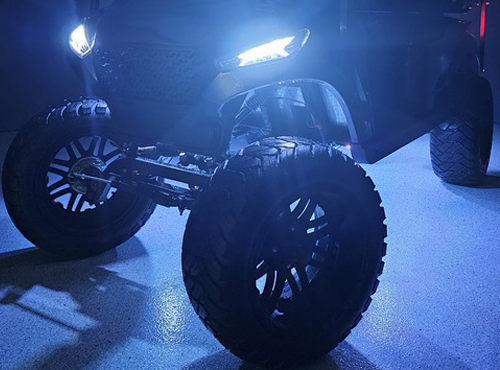 Golf cart wheel with blue LED lights at night
