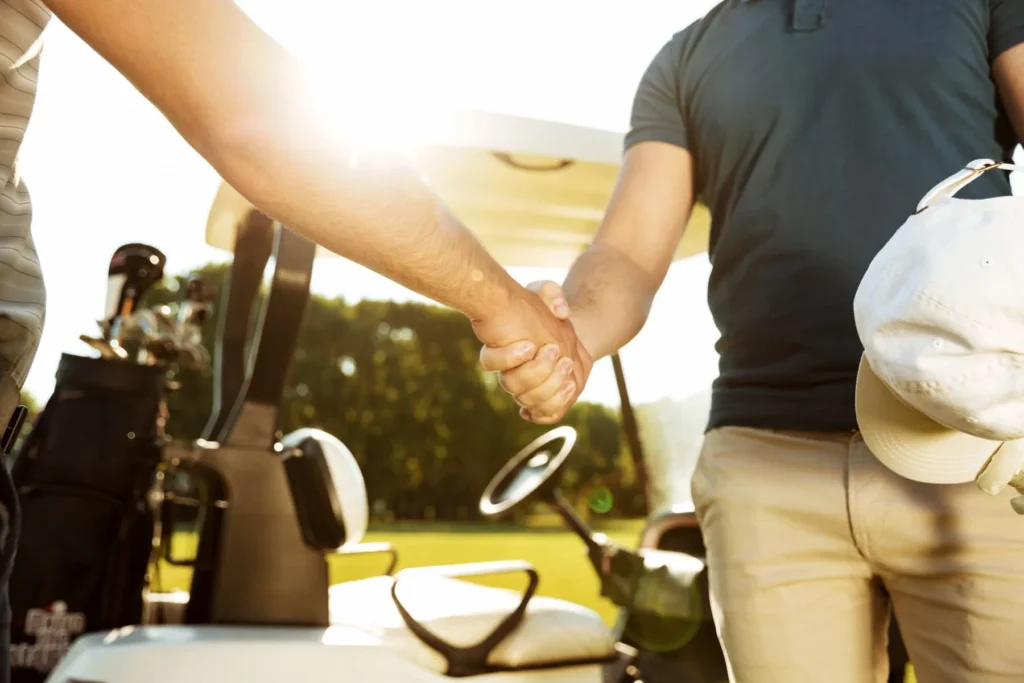 a golf cart buyer hand shaking with golf cart dealer in Austin